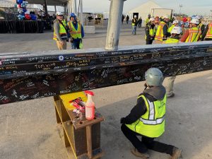 The Final Beam of the Buffalo Bills stadium is being signed by all the workers that made this project possible.