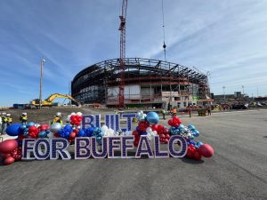 Wide view of a crane placing one of the last few steel beams for the new Buffalo Bills Stadium.