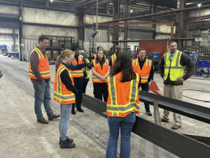 American Institute of Steel Construction members watching the processes used at the Mid West Division facility