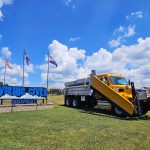 The Viking Cives Midwest Sign with a Dump body truck parked next to it.